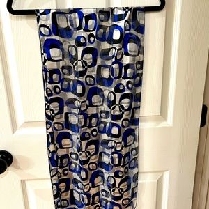 Geometric design woman’s scarf color is blue, black, and white